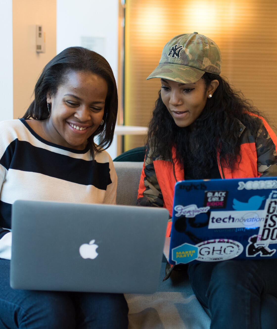 Two black women using laptop